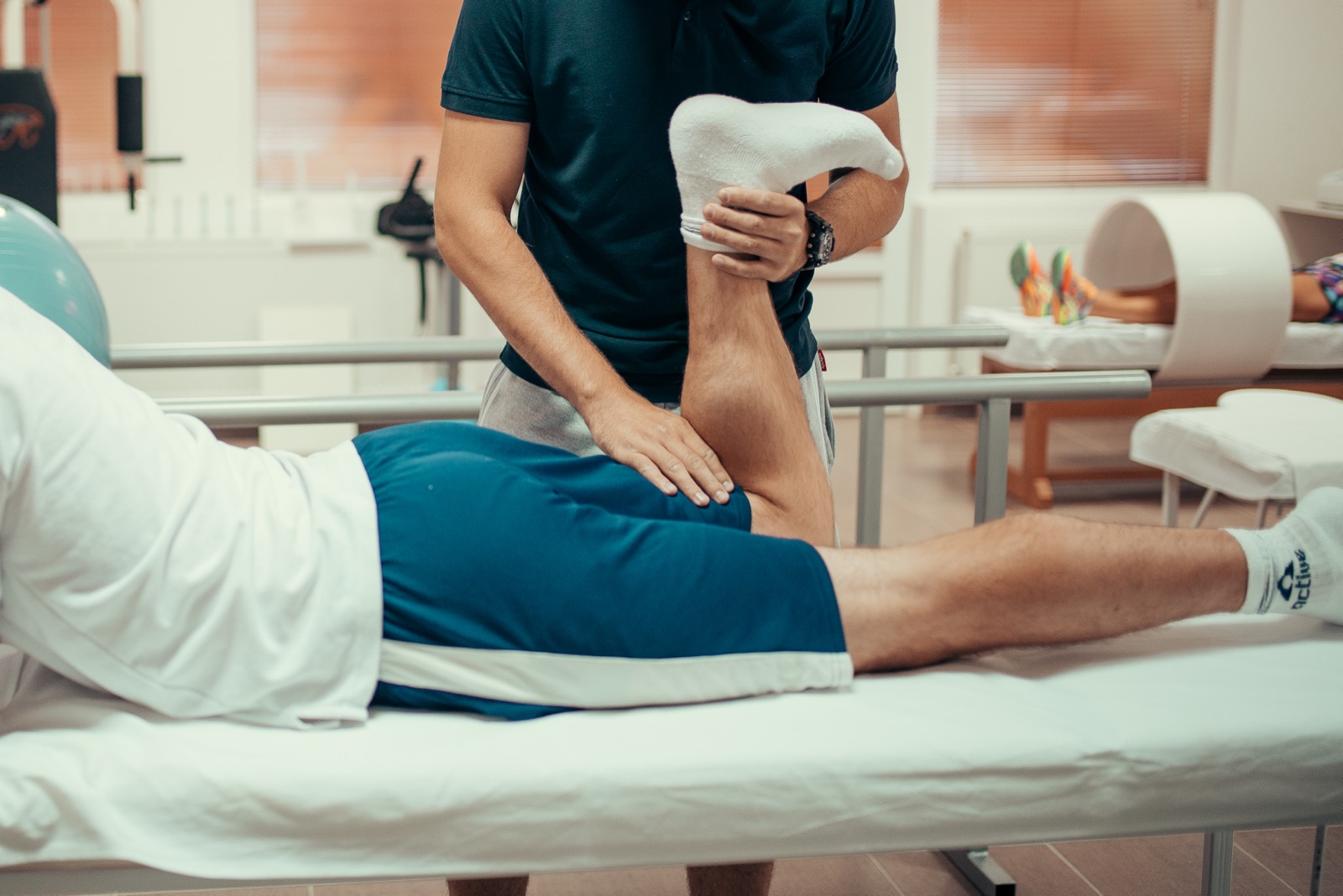 Physiotherapist performing hands-on treatment for a patient's lower back